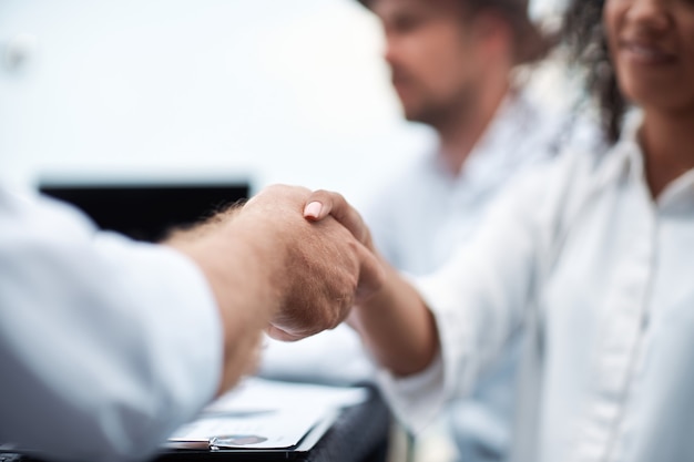 Handshake of international business partners close up