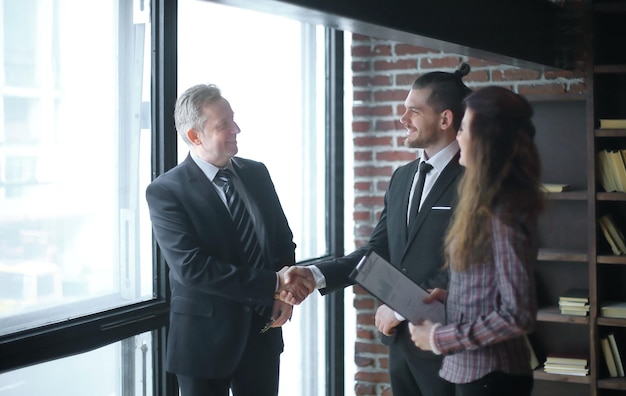 Handshake is serious business partners in the office