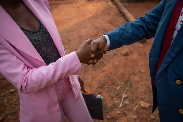 Handshake between a man and a woman concept of equal\
opportunity and equality at work between opposite gender