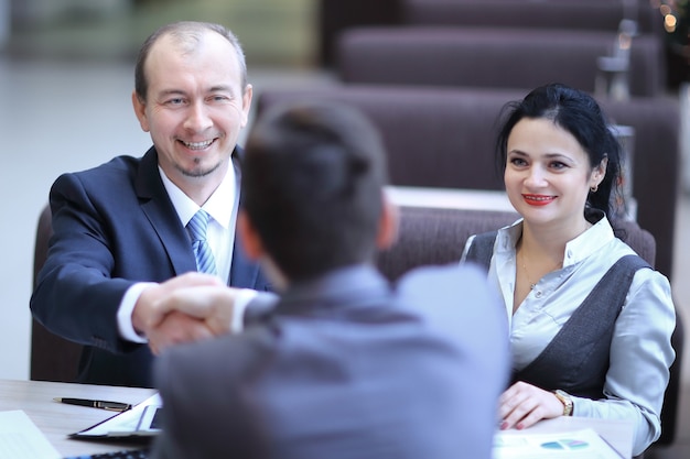 Handshake Manager and customer in a modern office.meetings and collaborations.