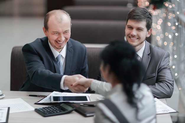 Handshake Manager and customer in a modern office.meetings and collaborations.