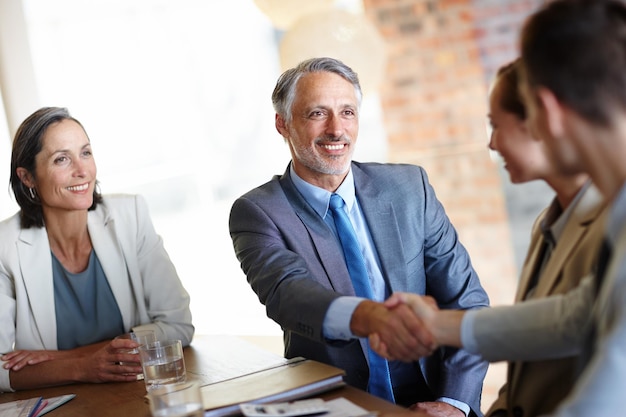 Photo handshake meeting and business people in office for teamwork partnership or collaboration in boardroom introduction recruitment and shaking hands for negotiation agreement or company onboarding