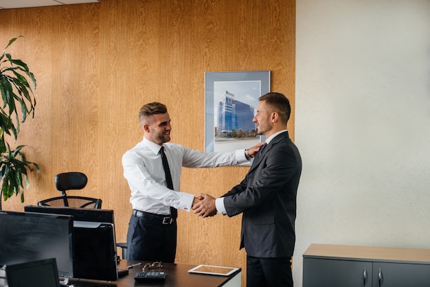 Handshake of partners, completion of the transaction in the office. Business