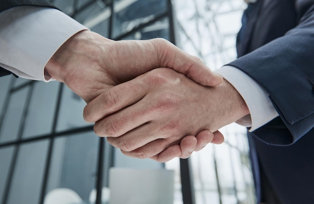 Handshake of two businessmen in a conference room closeup