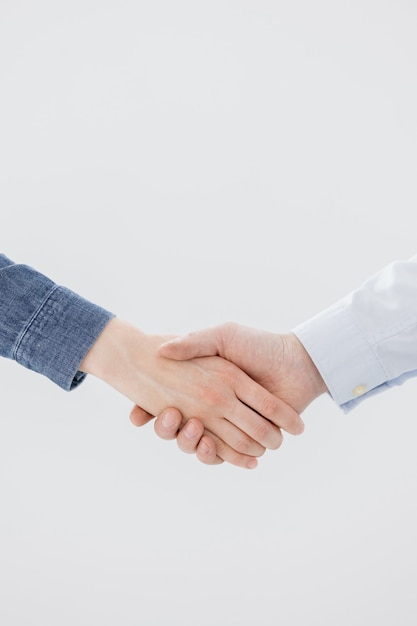 A handshake of two people a man and a woman business partners greet