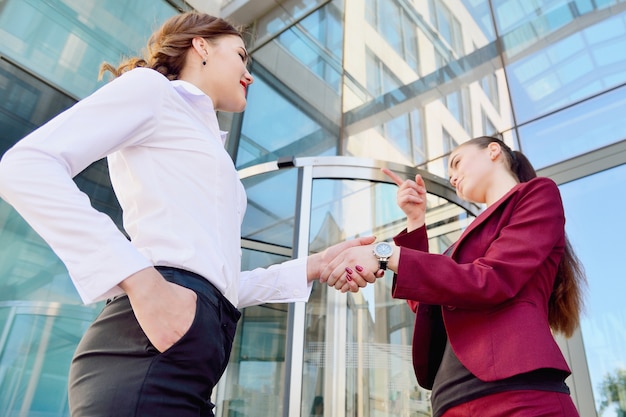 Foto stretta di mano di due giovani ragazze