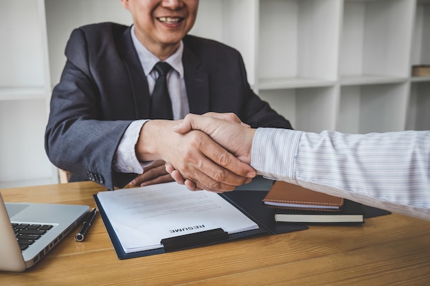 Handshake while job interviewing, candidate shaking hands with Interviewer or employer