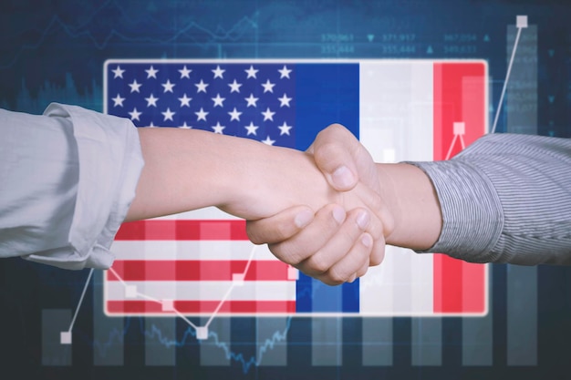 Handshake with America and France flag background