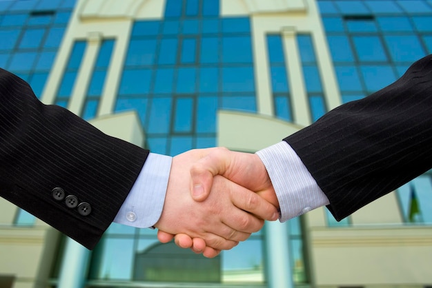 Handshake with modern skyscrapers as background