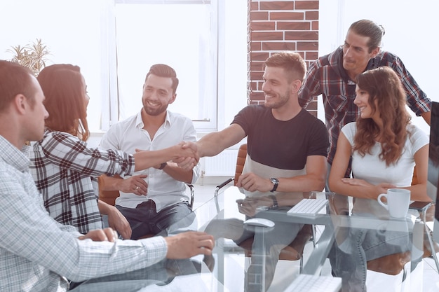 Handshake of young designers at a meeting