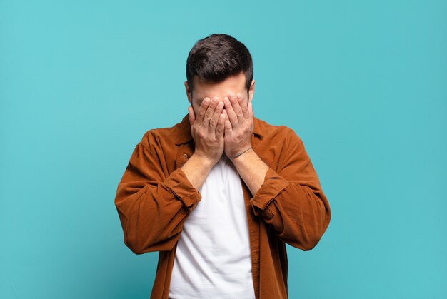 Handsome adult blond man feeling sad