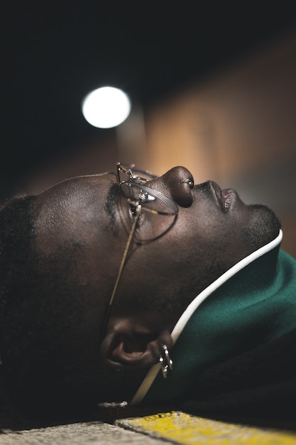 Photo handsome african-american guy with street glasses. black man serious