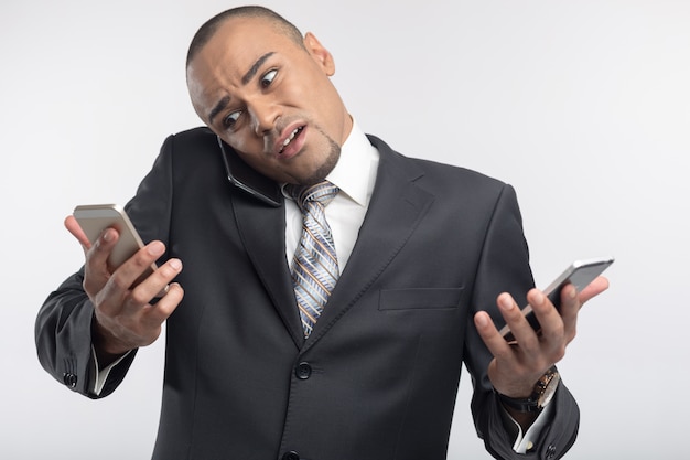 Handsome afro businessman using his smartphone portrait