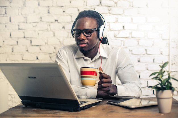 Handsome Afro man working on a laptop