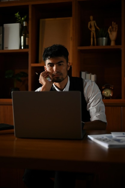 Handsome asian businessman or male executive manager working in his private office