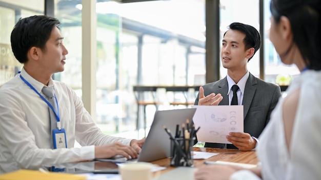 A handsome Asian male CEO giving his opinions to a financial team in the meeting