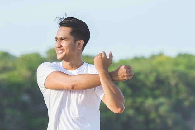 Handsome asian male warming up