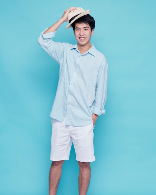 Handsome Asian man in a blue shirt with a hat