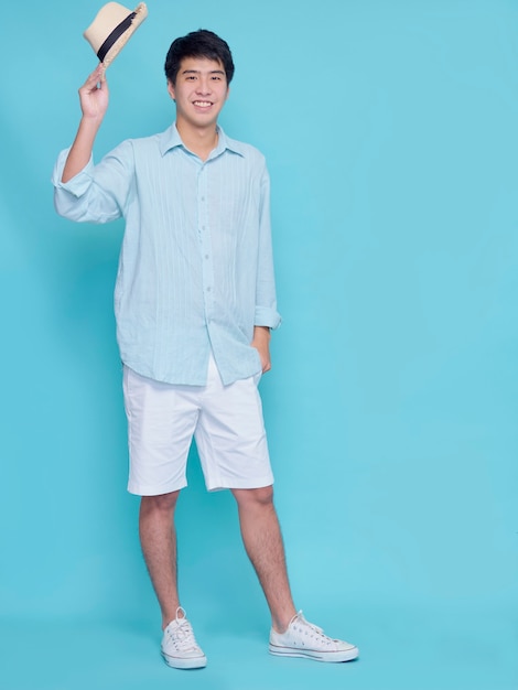 Handsome Asian man in a blue shirt with a hat