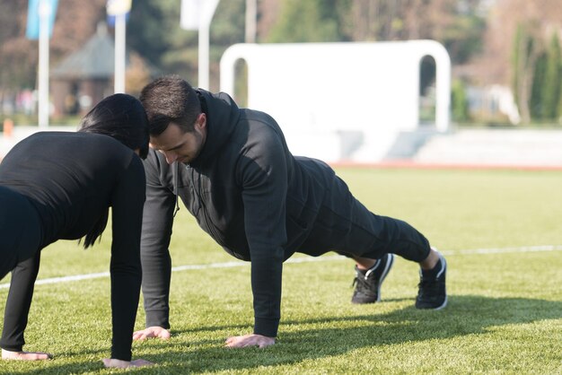 Handsome Athlete Doing Heavy Weight Exercise For Back On Machine