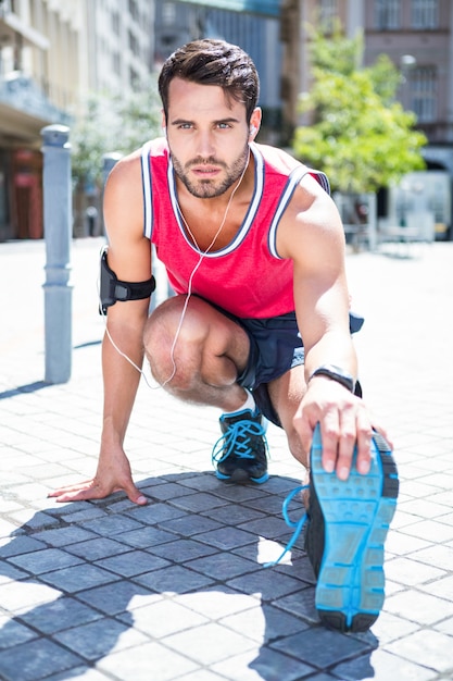 Handsome athlete doing a leg stretching