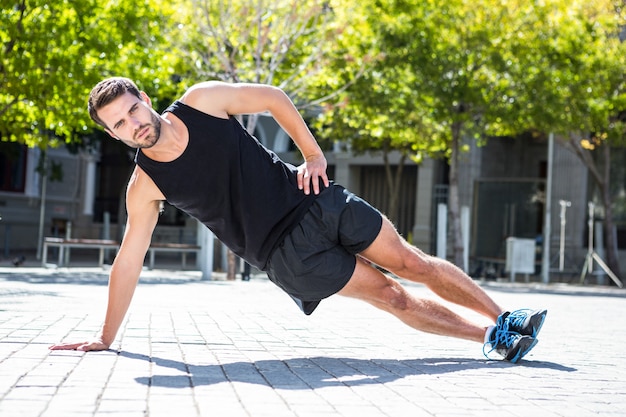 Handsome athlete doing a side plank