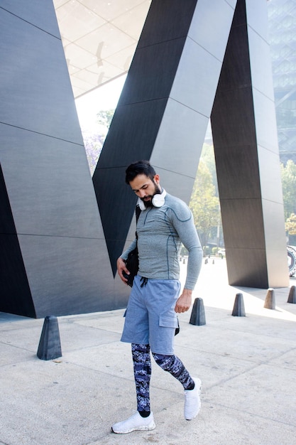 Handsome athletic man walking in the street