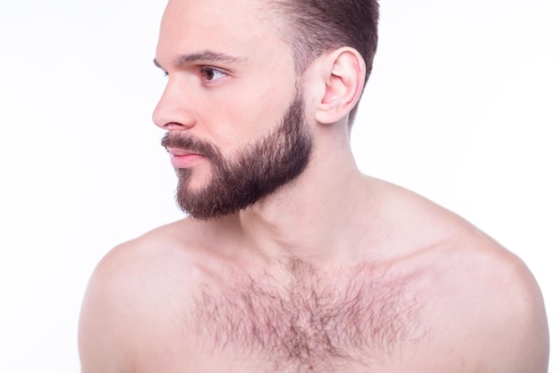 Handsome attractive brutal modern manly confident naked man touching his perfect ideal face skin looking at camera and posing isolated on white background after bath