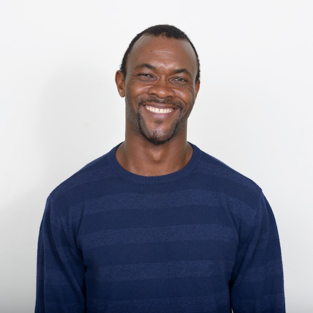 handsome bearded African man against white wall