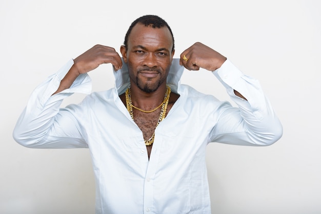  handsome bearded African man as gangster against white wall