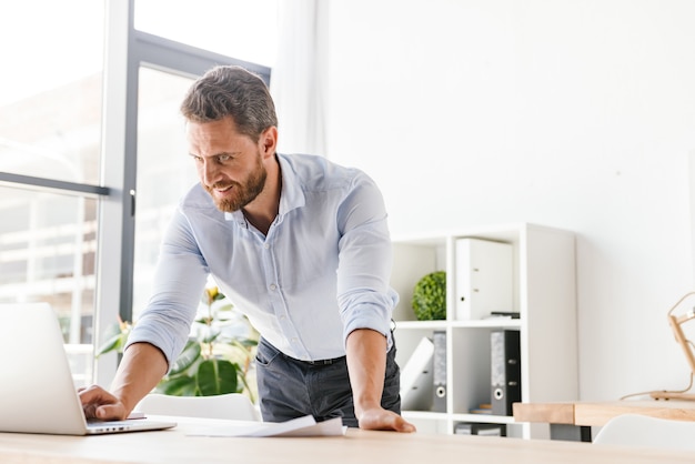 Handsome bearded business man in office working