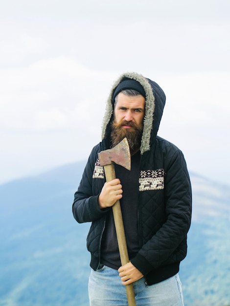 Photo handsome bearded hipster with ax