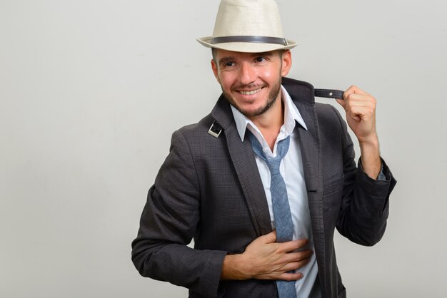 handsome bearded Hispanic businessman wearing hat on white