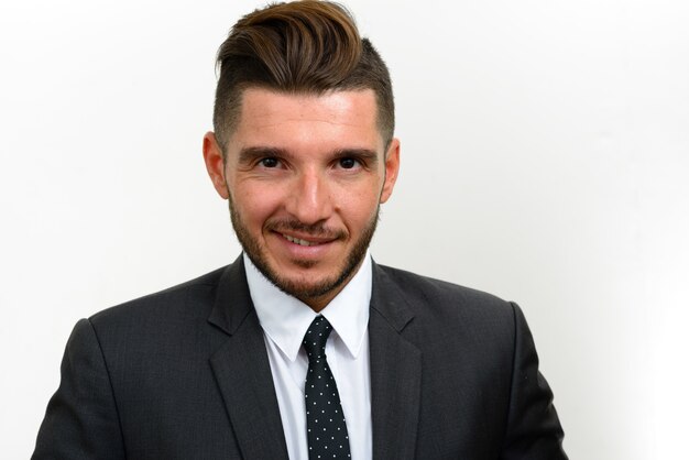 handsome bearded Hispanic businessman wearing suit on white