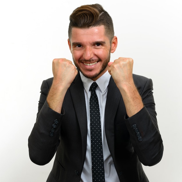 handsome bearded Hispanic businessman wearing suit on white