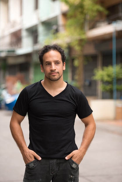 Handsome bearded Hispanic man in the streets outdoors