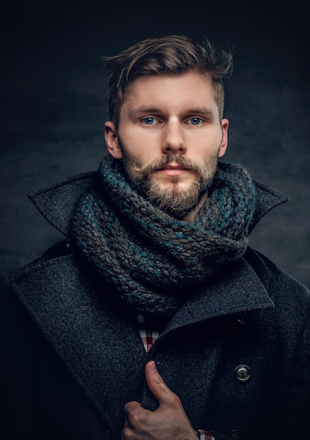 Handsome bearded male wearing a wool jacket and a scarf.