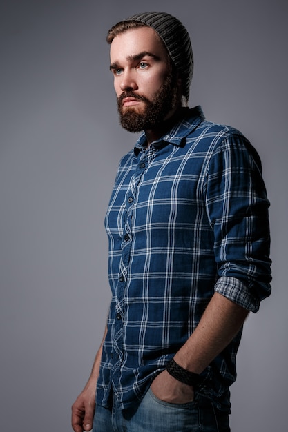 Handsome bearded man in checkered shirt