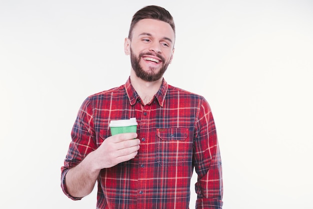 Handsome bearded man drinks coffee from paper cup Coffee to go Cafe concept Coffee shop Good morning Happy guy enjoy fresh hot tea Smiling barista offer you beverage