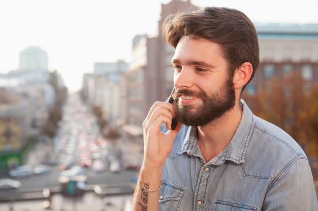 Handsome bearded man enjoying warm day at the city