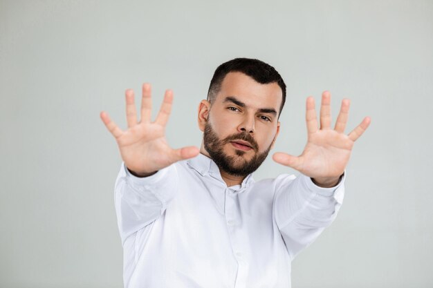 Handsome bearded man showing stop gesture