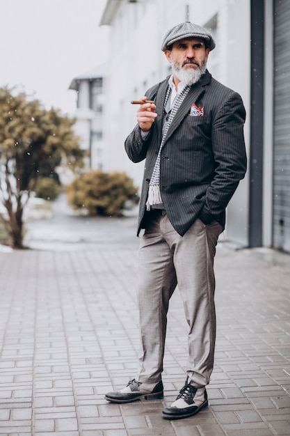 Handsome bearded man smoking cigarette