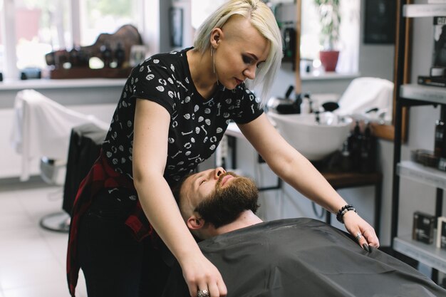 Photo handsome bearded and moustache man has shave in barbershop.