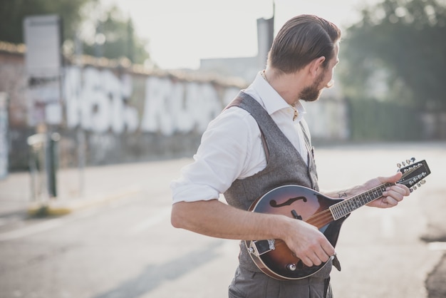 handsome big moustache hipster man playing mandolin