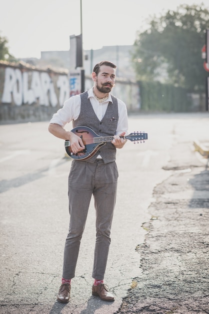 handsome big moustache hipster man playing mandolin