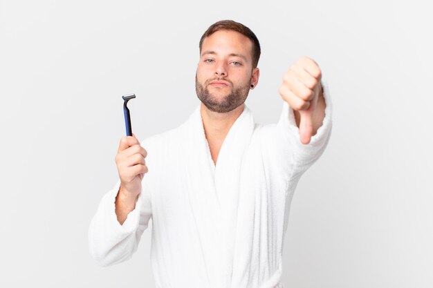 Handsome blonde man feeling cross,showing thumbs down. shaving concept