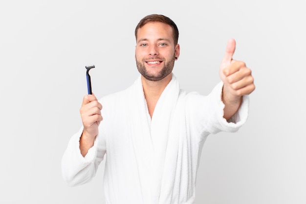Handsome blonde man feeling proud,smiling positively with thumbs up. shaving concept
