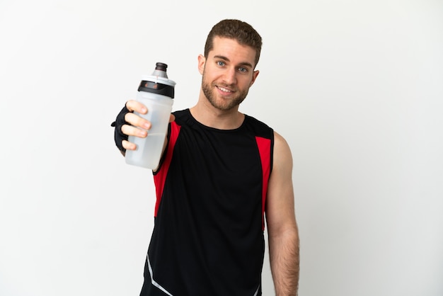 Handsome blonde man over isolated white background with sports water bottle