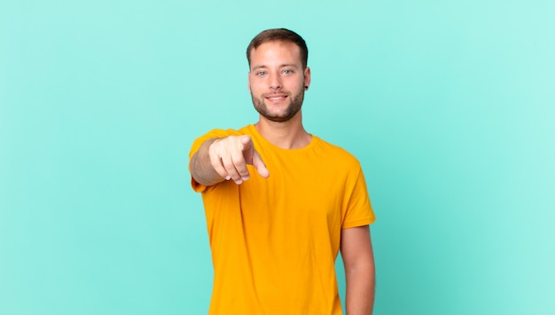 Handsome blonde man pointing at camera choosing you