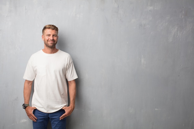 Handsome blonde man proud or satisfied expression